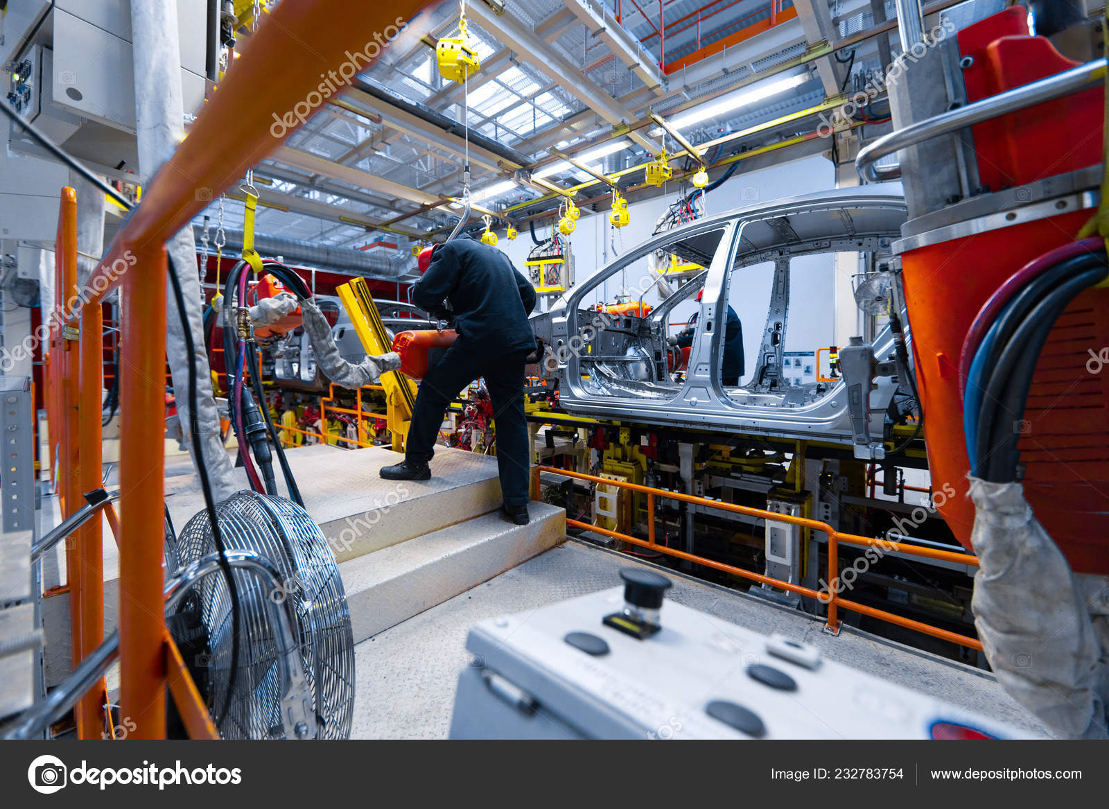 Engineer assemble the car on the production line. Car manufacturing plant  Stock Photo by ©fotoevent.stock 232783754