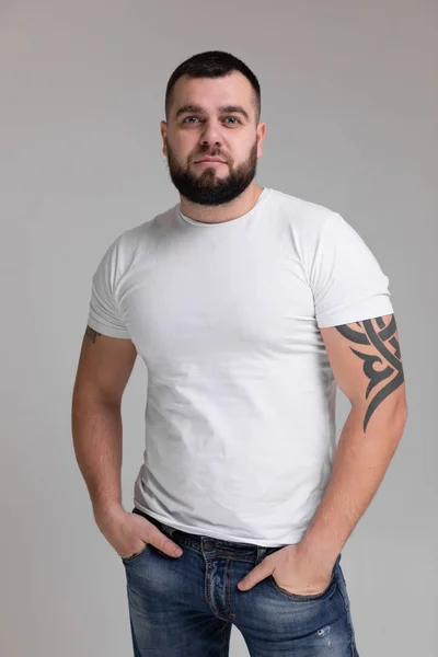 Vertical Portrait of strong man isolated on light background — Stock Photo, Image