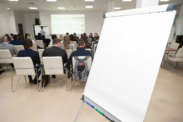 Board on background of audience in conference room. Business concept — Stock Photo, Image