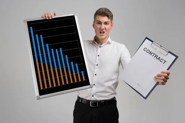Young man holding a poster with statistics and contract isolated on a light background — Stock Photo, Image