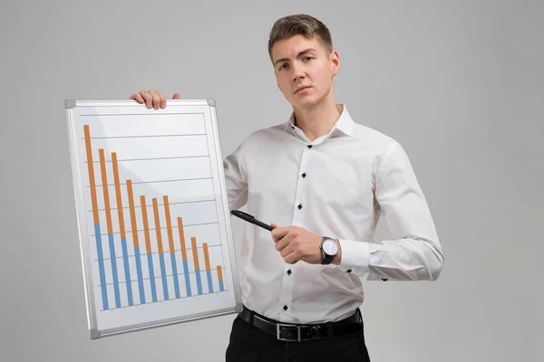 Young man holding a poster with statistics isolated on a light background — Stock Photo, Image
