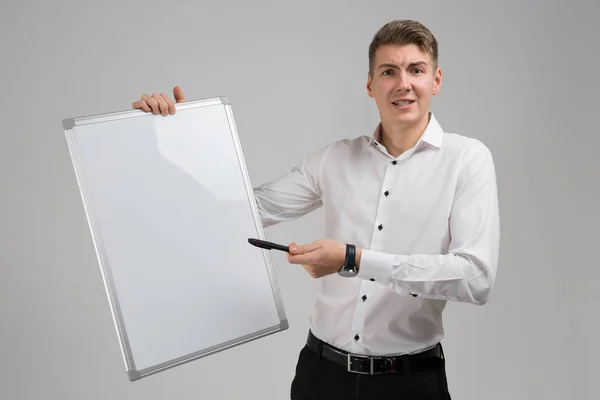 Portrait of young man with clean magnetic Board and marker in his hands isolated on white background — Stock Photo, Image
