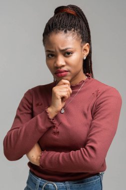 Beyaz arka plan üzerinde izole güzel siyah kadın ayakta tutma çene dikey portresi