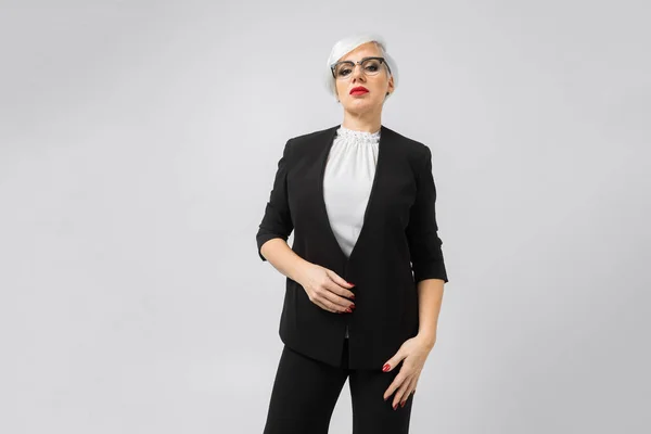 Portrait of a confident business lady in a strict suit isolated on a light background — Stock Photo, Image