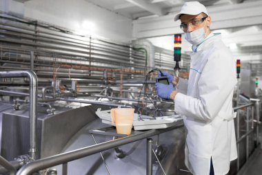 maskeli adam ve bornoz dosimeter süt fabrikaya bağlanır.