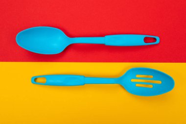 Sarı-kırmızı zemin üzerine izole plastik mutfak aletleri