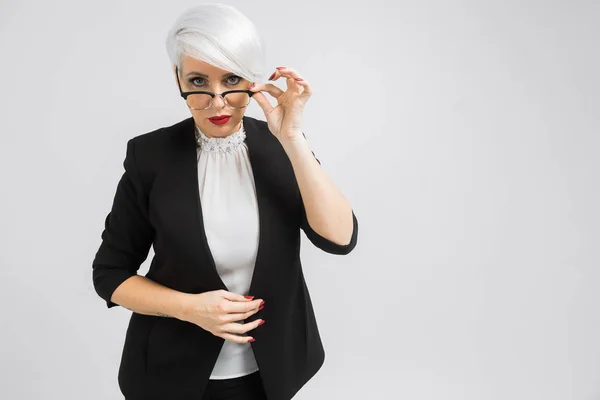 Portrait of a confident business lady in a strict suit isolated on a light background