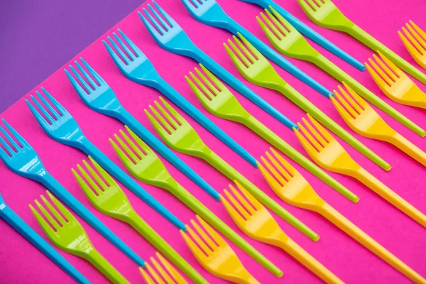 Many color plastic forks on a bright background — Stock Photo, Image