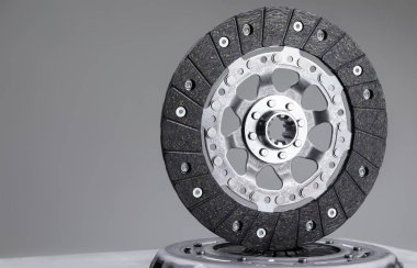 Car clutch plate on a gray background, new part, car warranty service clipart