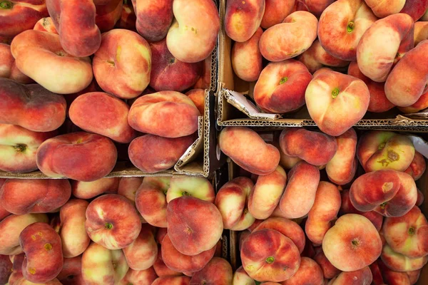 Fig peach, flat peaches at farmers market or grocery shelves. Top view, background for agriculture news or illustration. — Stock Photo, Image
