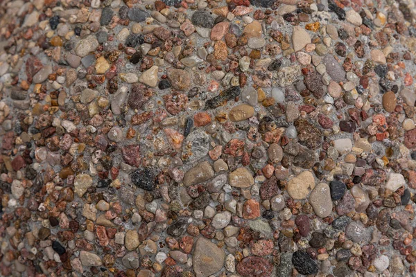 Shallow stones and pebbles texture on ground. Nature pattern of sandy colours. — Stock Photo, Image