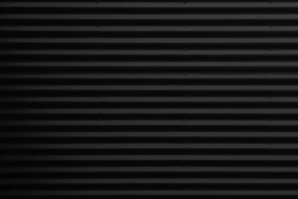 Frontansicht der metallisch glänzenden schwarzen Wellblechoberfläche — Stockfoto