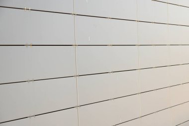 Küçük metal dik levhalardan yapılmış bir binanın açık gri metal duvar