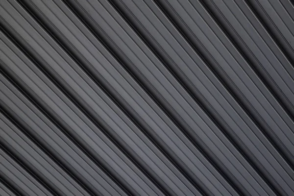 Vista diagonal na superfície de construção do relevo do metal cinzento no fundo . — Fotografia de Stock