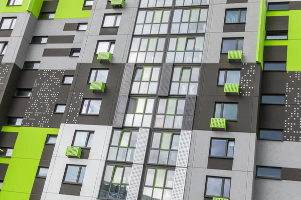 Fragment of new block of flats painted in vibrant green and grey — Stock Photo, Image