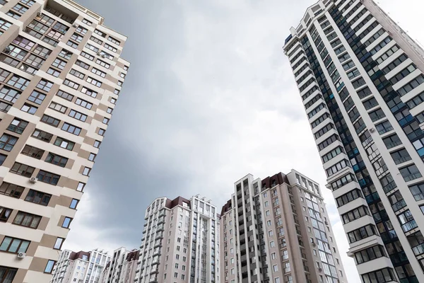 Ground view of cutting-edge architecture apartment buildings at dormitory district, cloudy sky background