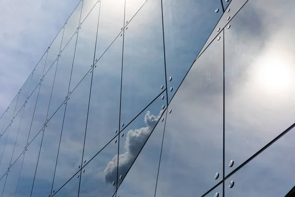 Shiny glass facade of business centre of open space office building with sky reflection, diagonal view. — Stock Photo, Image