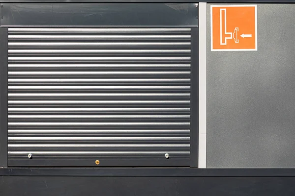 Metal roller shutter door in a black wall