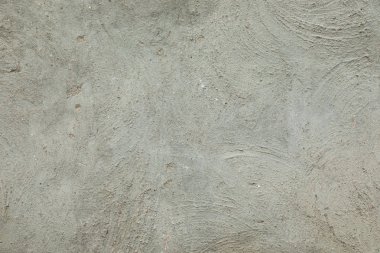 Açık gri, boş bir evin beton duvarı.