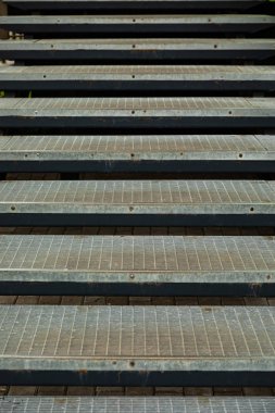 Yüksek apartman girişinin yanındaki metal kafes merdivenleri.