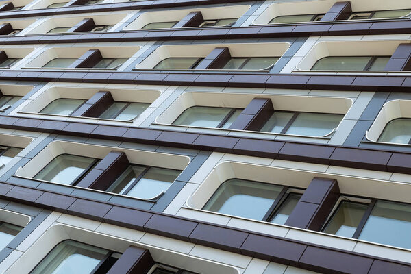 Square streamline shaped windows on contemporary urban luxury designed accomodation facade. creative arcitecture, exterior