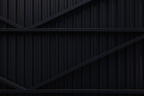 Black corrugated metal surface of steel gates