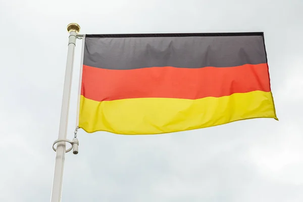 German flag waving in the wind against sky