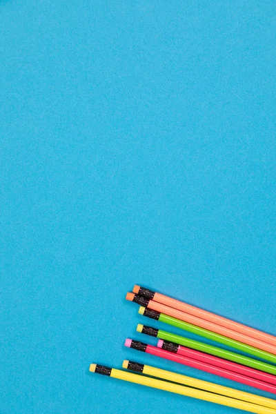 Yarı görünür renkli pastel boyalar mavi bir yüzey kesiminde yatıyor.