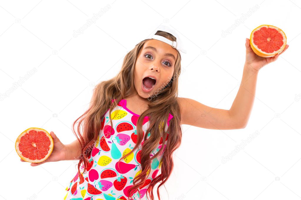cute little girl posing with fruit against white background  