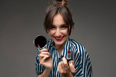 Güzel esmer kadın makyaj yapıyor. 