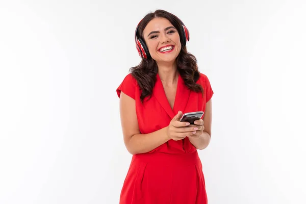 beautiful woman in red with headphones and phone