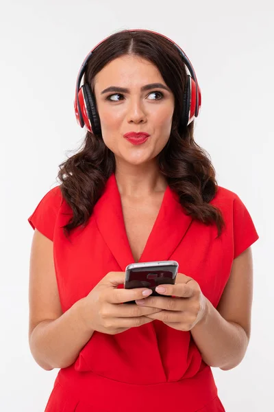 beautiful woman in red with headphones and phone