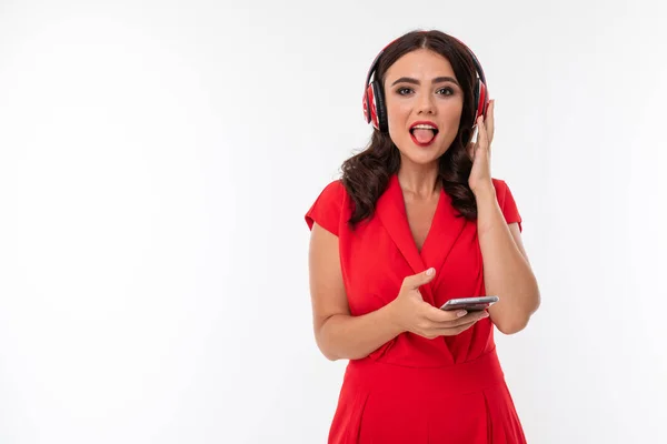 beautiful woman in red with headphones and phone