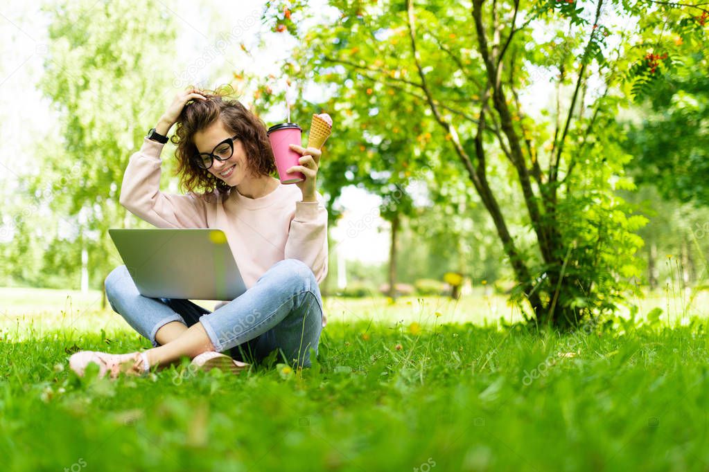 girl with ice cream, coffee and laptop outdoors