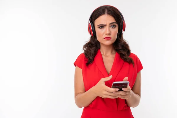 beautiful woman in red with headphones and phone