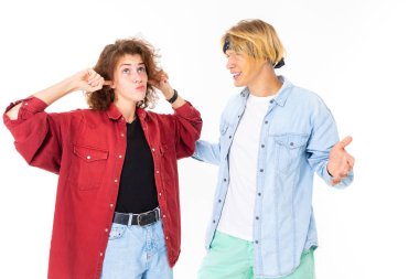 Woman and man posing against white background 