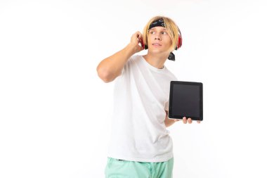 man posing in headphones with digital tablet against white background  