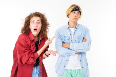 Woman and man posing against white background 