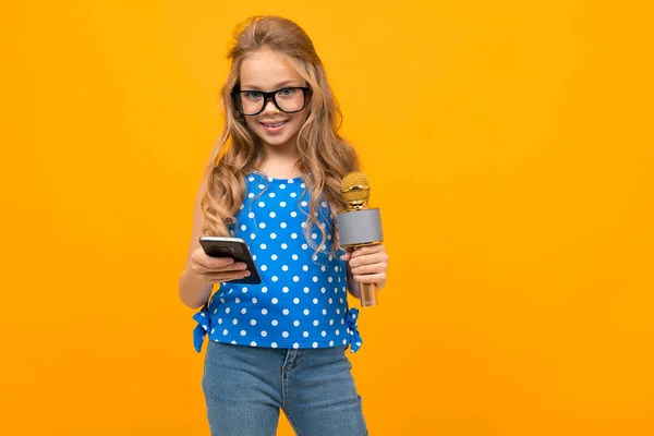 little girl with phone and microphone