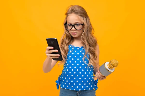 little girl with phone and microphone