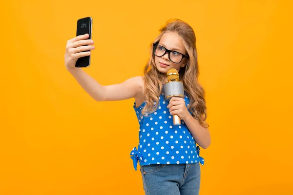 little girl with phone and microphone