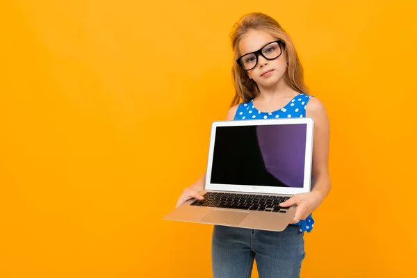 Mała Dziewczynka Pozowanie Okularami Laptop Pomarańczowym Tle — Zdjęcie stockowe