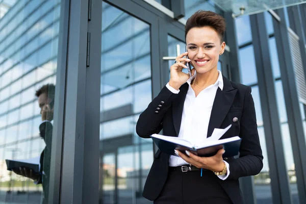 bussiness woman with notebook posing outdoors