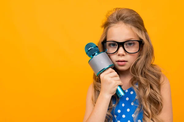 Menina Bonito Com Microfone Posando Contra Laranja — Fotografia de Stock