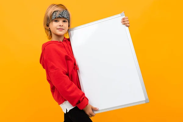 boy holding white board