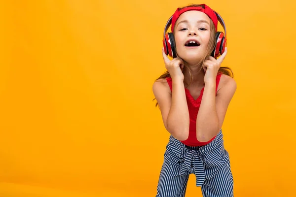 Cute Little Girl Słuchanie Muzyki Pozowanie Pomarańczowym Tle — Zdjęcie stockowe