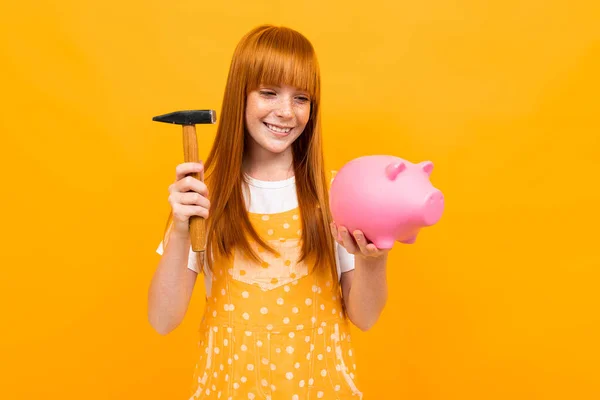 Cute Girl Piggy Bank Orange Background — Stock fotografie