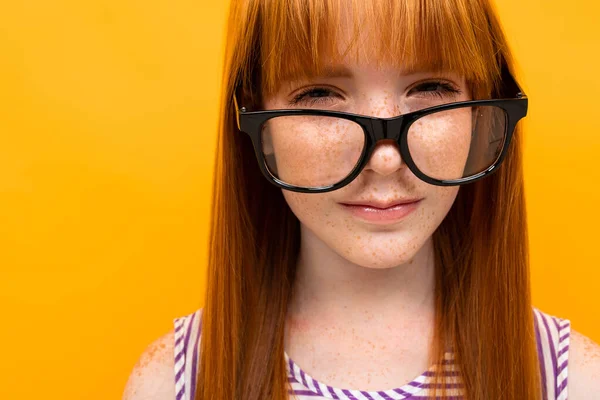 girl with bad vision against orange background