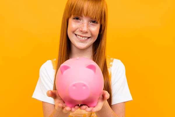 Cute Girl Piggy Bank Orange Background — Stock fotografie