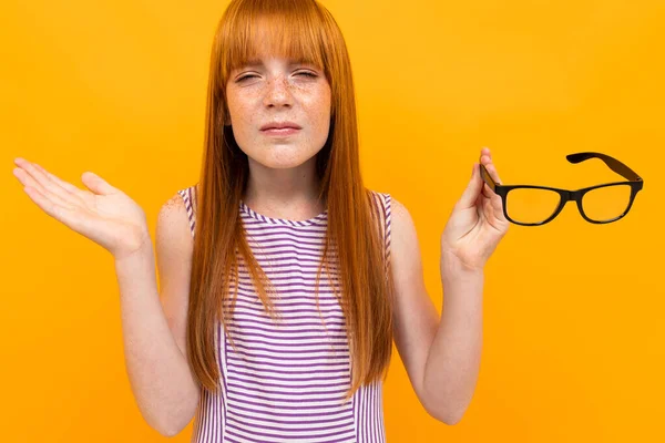 girl with bad vision against orange background